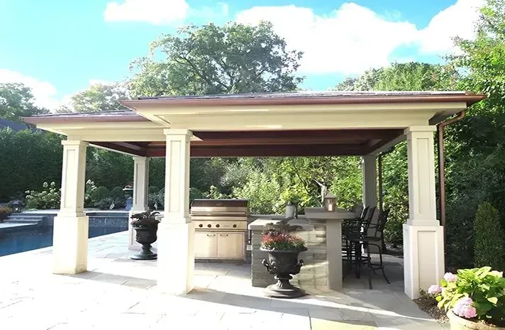 A gazebo with a grill and a table underneath it