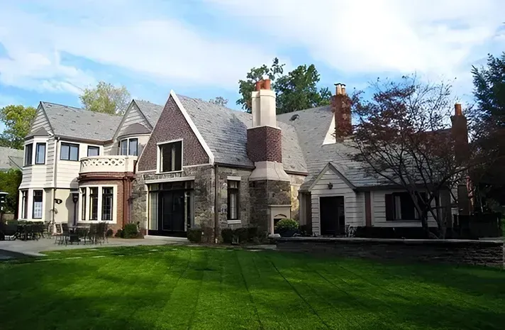 A large house with a large lawn in front of it
