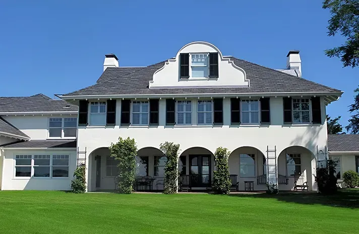 A large house with a lot of windows and shutters