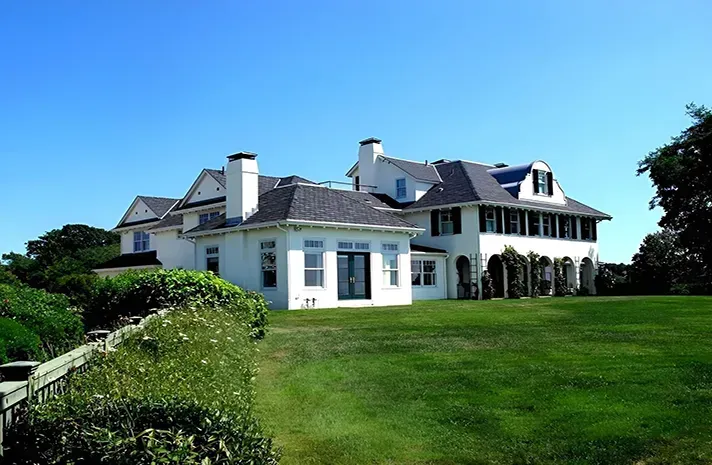 A large house with a lot of windows and shutters