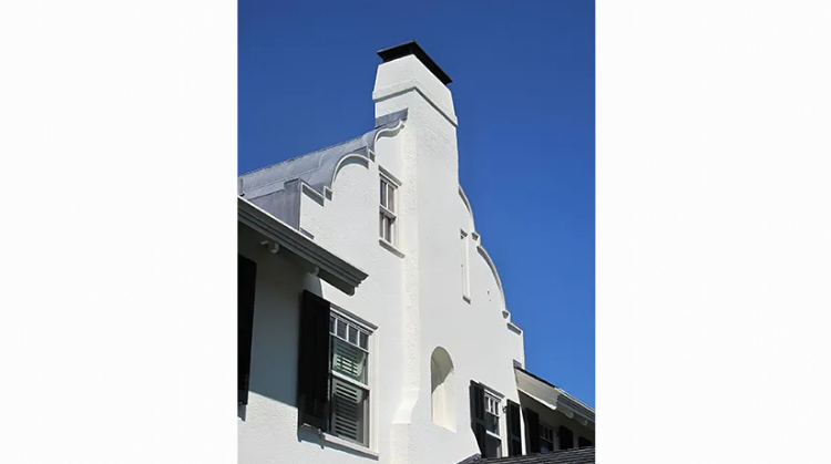 A large house with a lot of windows and shutters