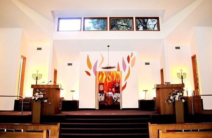 The inside of a church with a painting of flames on the wall