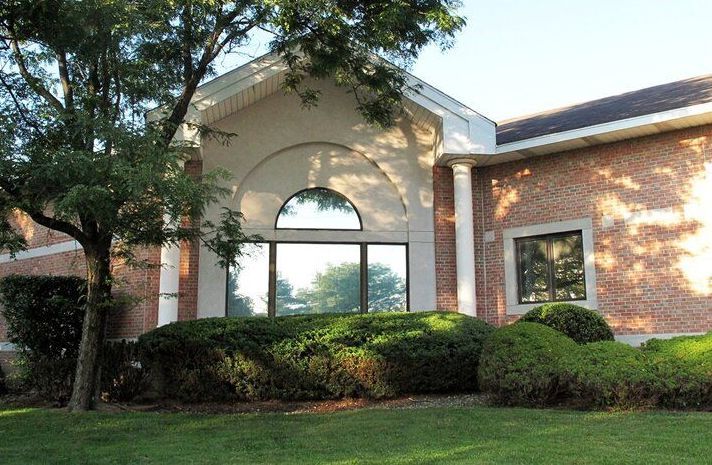 A brick building with a tree in front of it