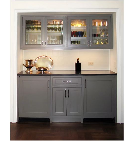 A kitchen with gray cabinets and glass doors.