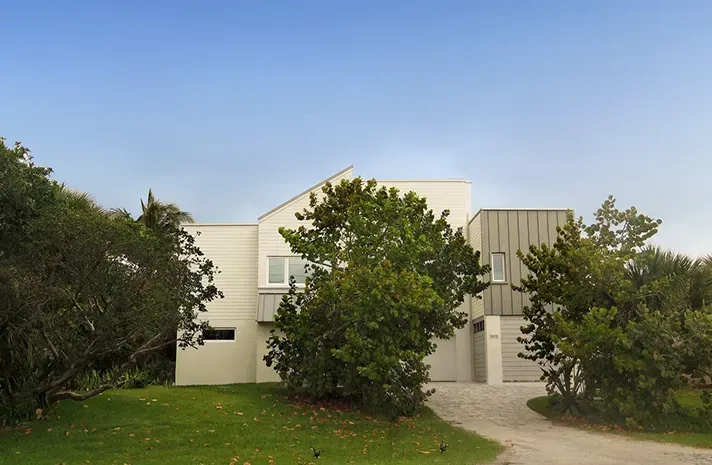 A large white house with trees in front of it