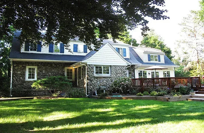 A large house with a large lawn in front of it