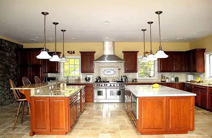 A large kitchen with two islands and stainless steel appliances