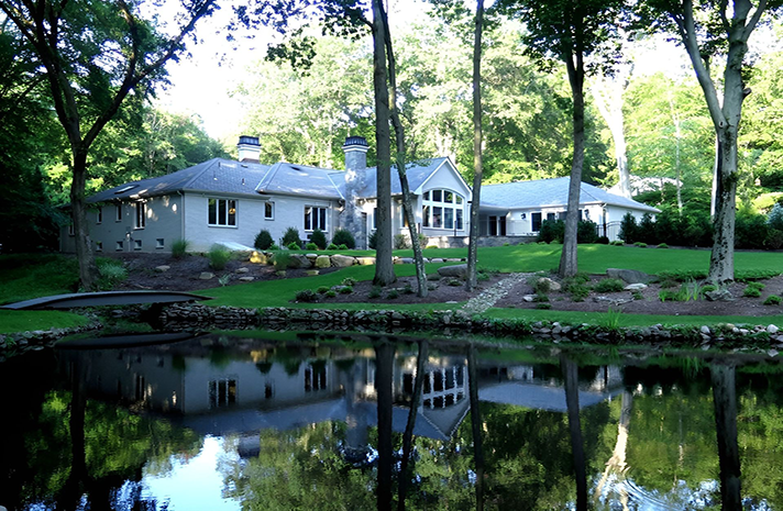 A house with a pond in front of it