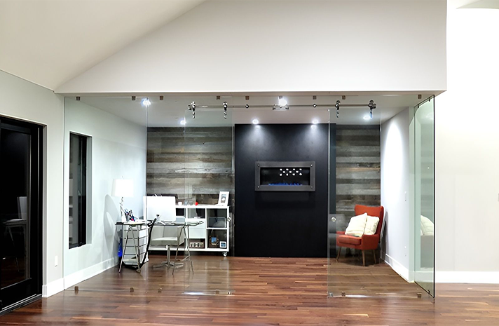 A living room with a fireplace and sliding glass doors.