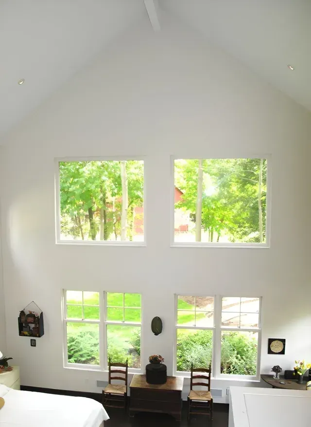 A room with a vaulted ceiling and lots of windows