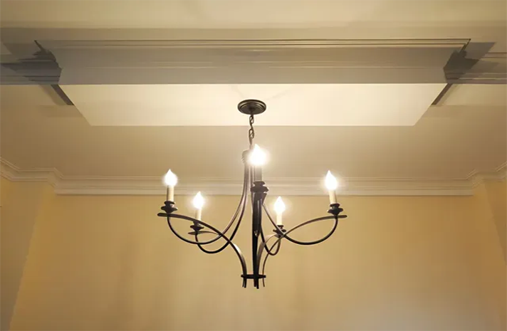 A chandelier is hanging from the ceiling in a room