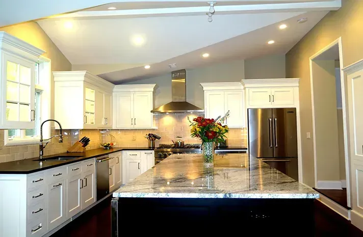 A kitchen with stainless steel appliances and white cabinets