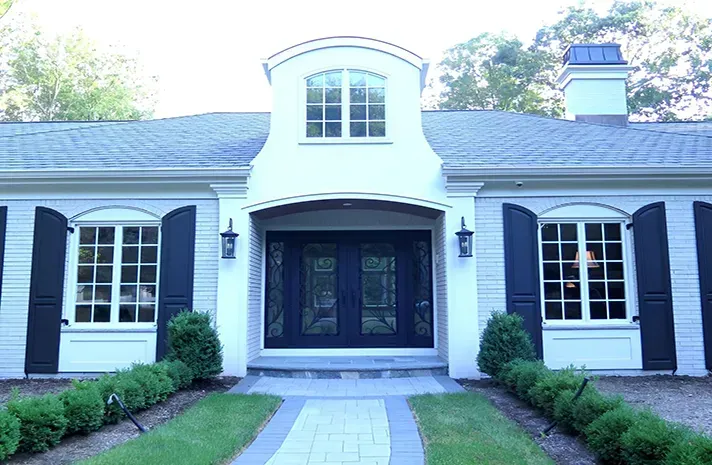 A white house with black shutters on the windows