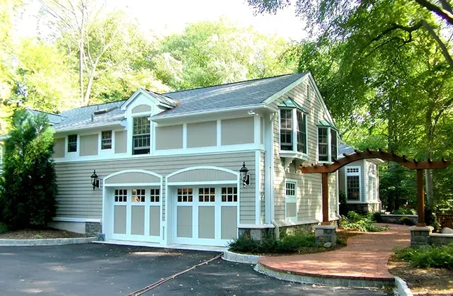 A large house with a garage and a walkway leading to it