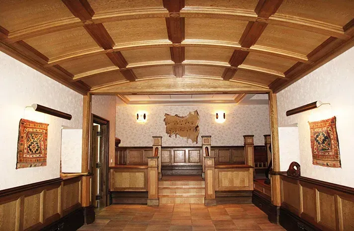 A hallway with a wooden ceiling and stairs