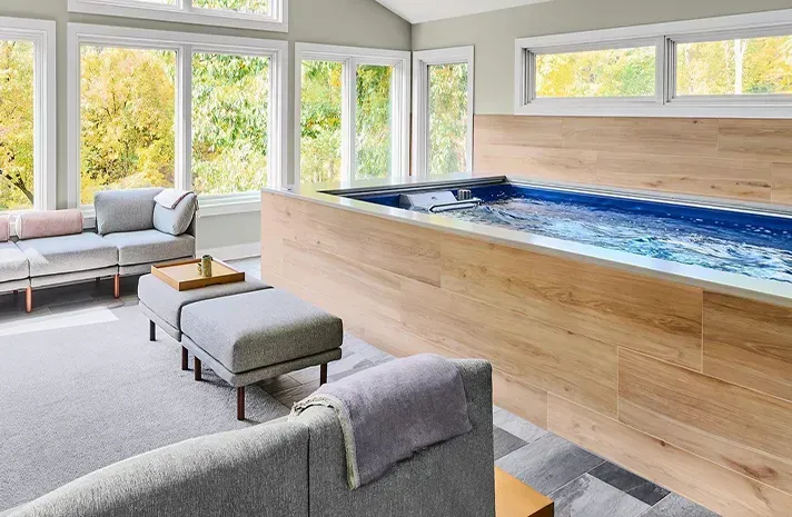 A living room with a swimming pool in the middle of it.