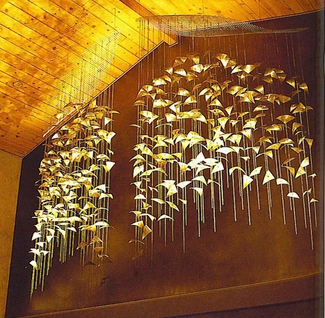 A bunch of birds are hanging from the ceiling