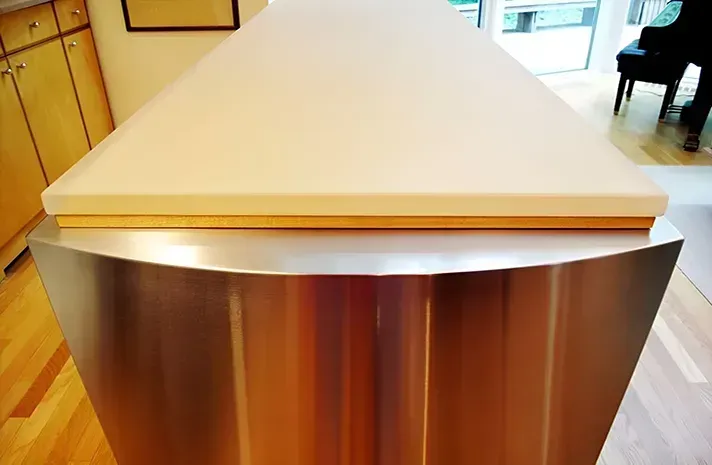 A stainless steel counter top with a wooden top in a kitchen.