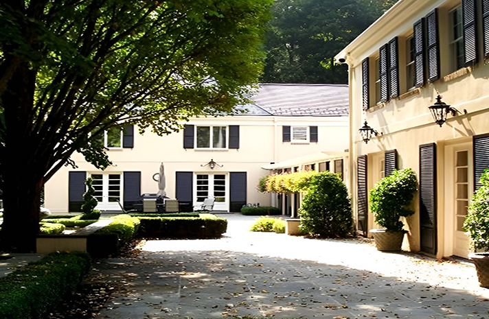A large white house with a driveway leading to it