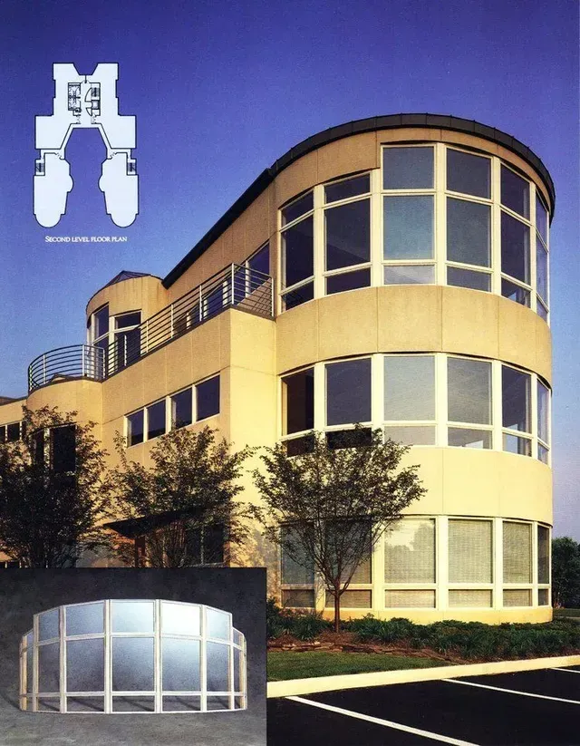 A large building with a lot of windows and the letter m above it