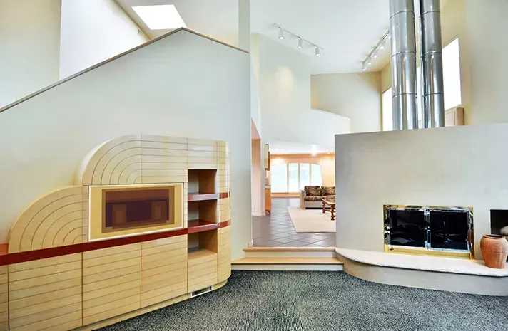 A living room with a fireplace and a staircase