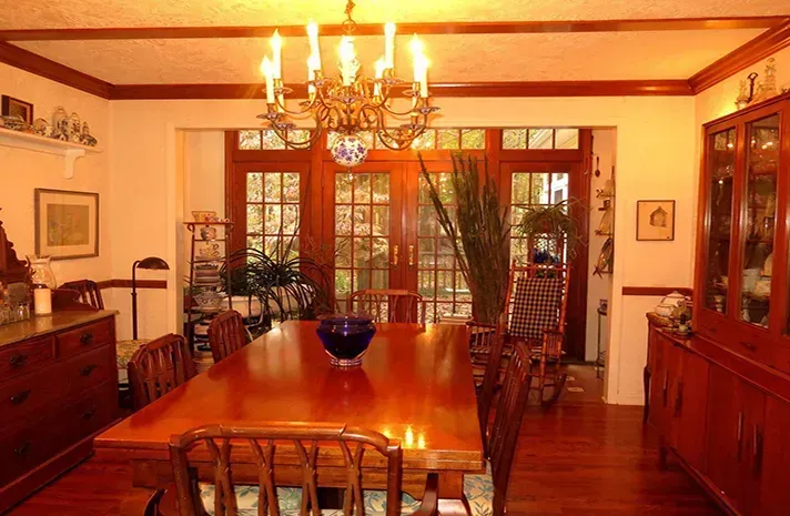 A dining room with a table and chairs and a chandelier