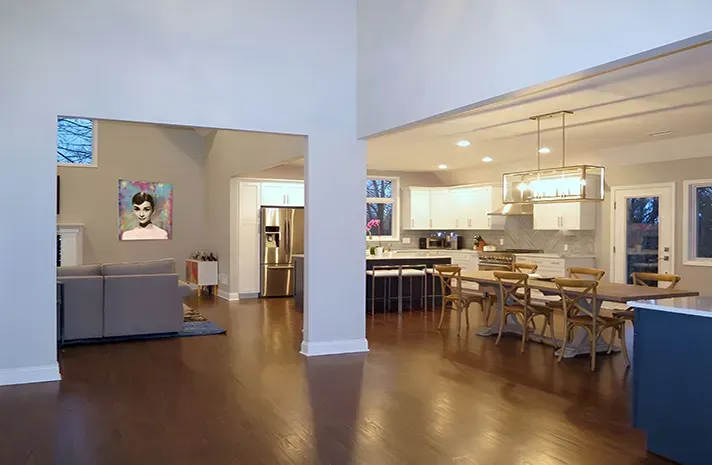 A living room , dining room , and kitchen in a house.