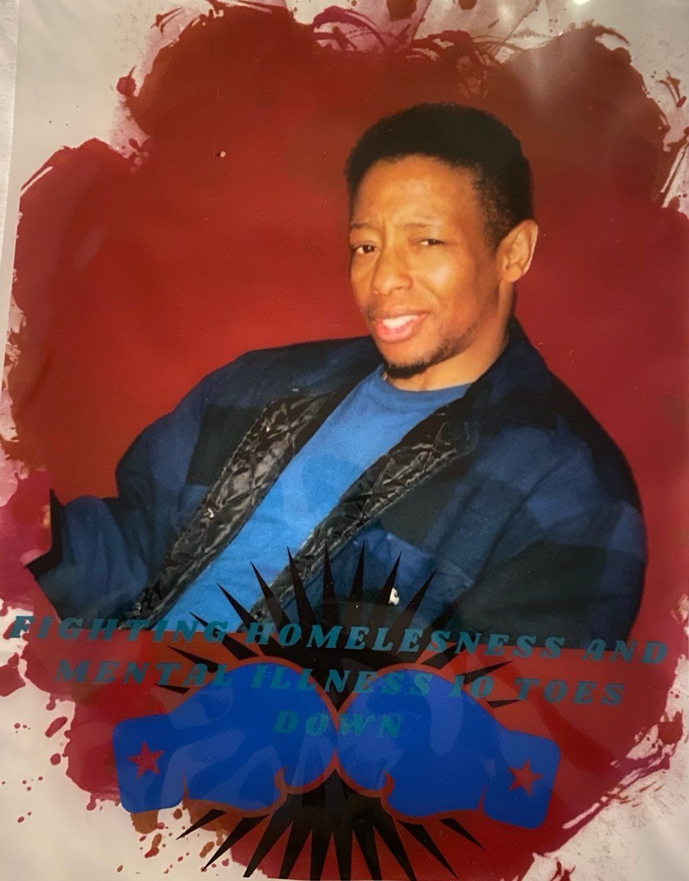 Portrait of a smiling man in a blue shirt against a red backdrop with decorative graphic accents