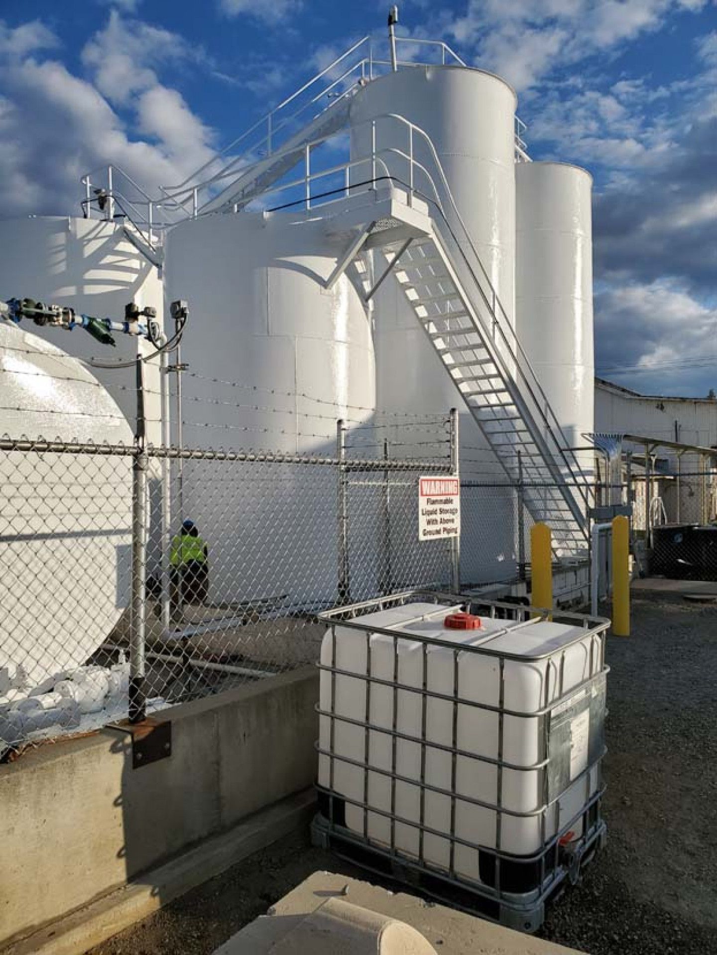 A large white tank with stairs leading up to it