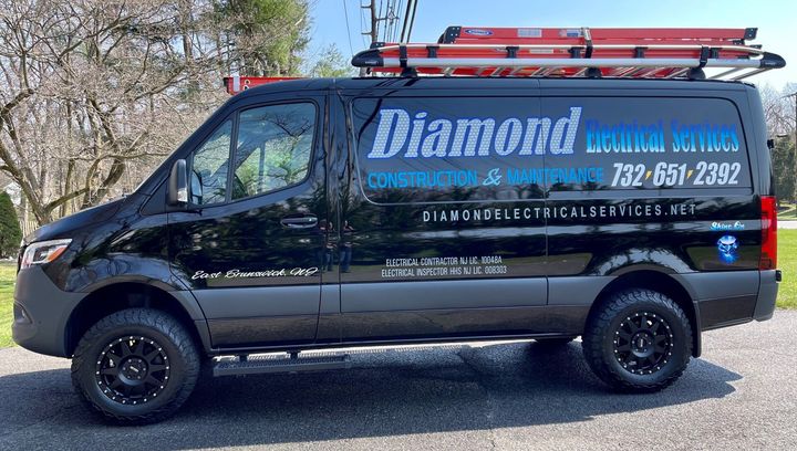 Black Diamond Heating & Cooling van parked outdoors with roof ladder rack and company phone number on the side