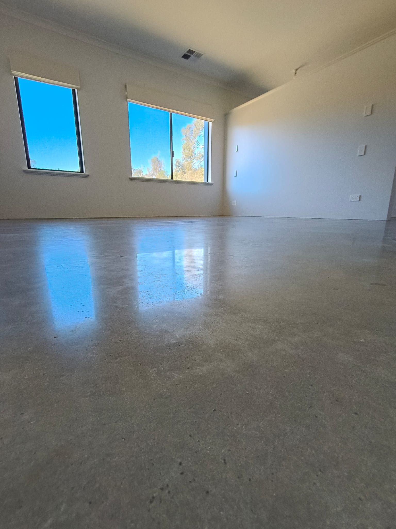 Modern living room with a burnished polished concrete floor