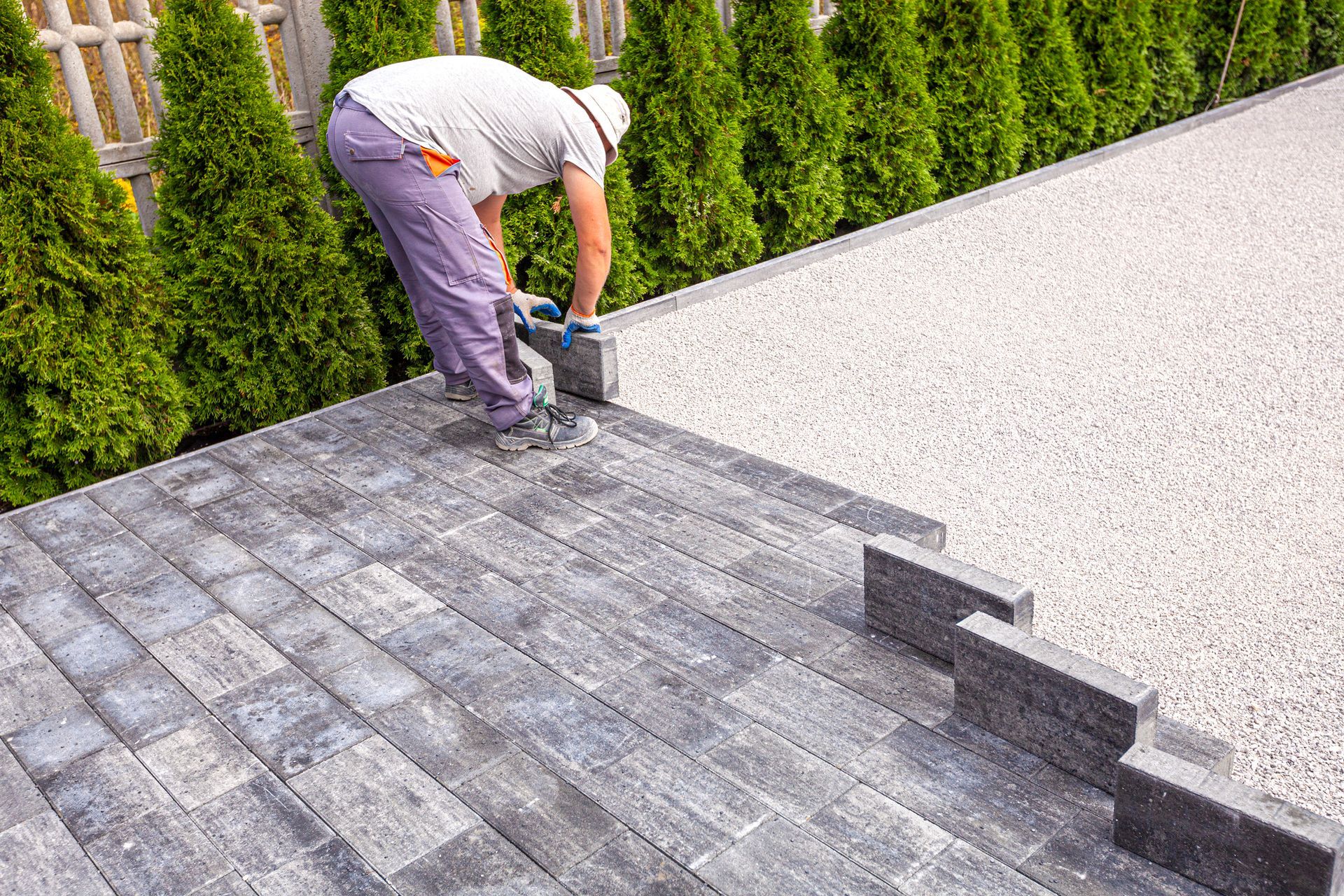 A man is laying paving stones.
