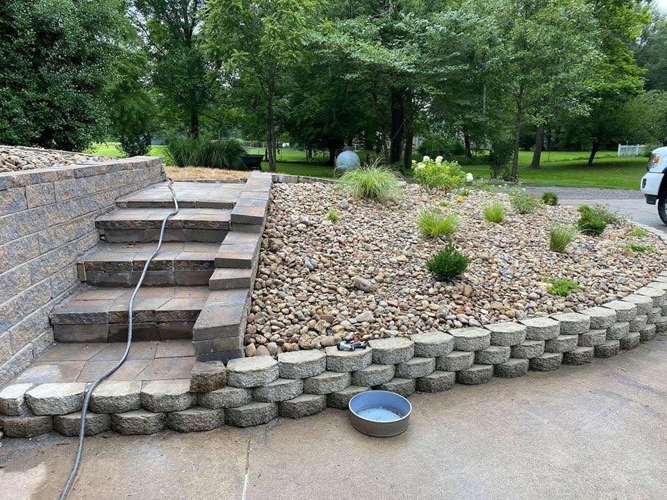 rock flower bed with retaining wall and stone steps