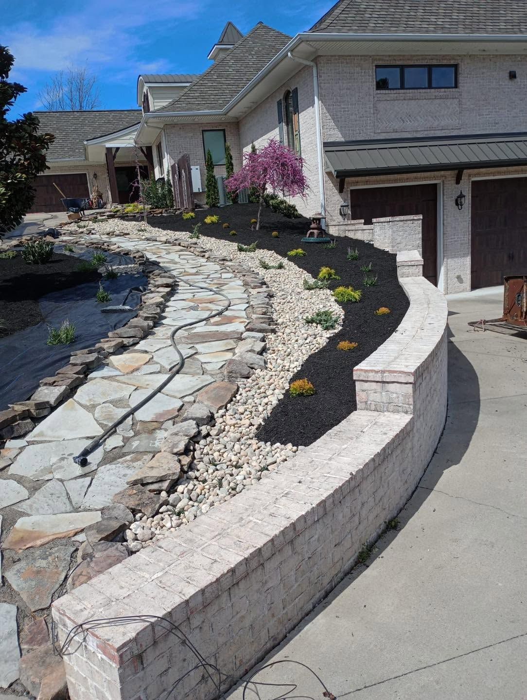 flower bed with stone paver walkway