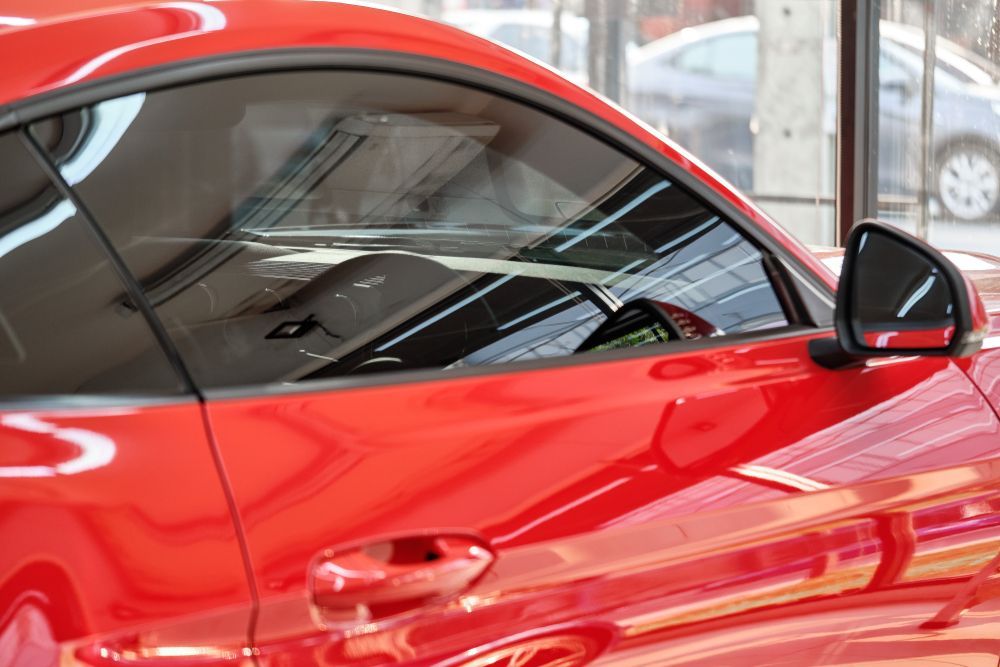A Red Sports Car Is Parked in A Showroom — Jetty Car Detailing Coffs Harbour in Coffs Harbour NSW