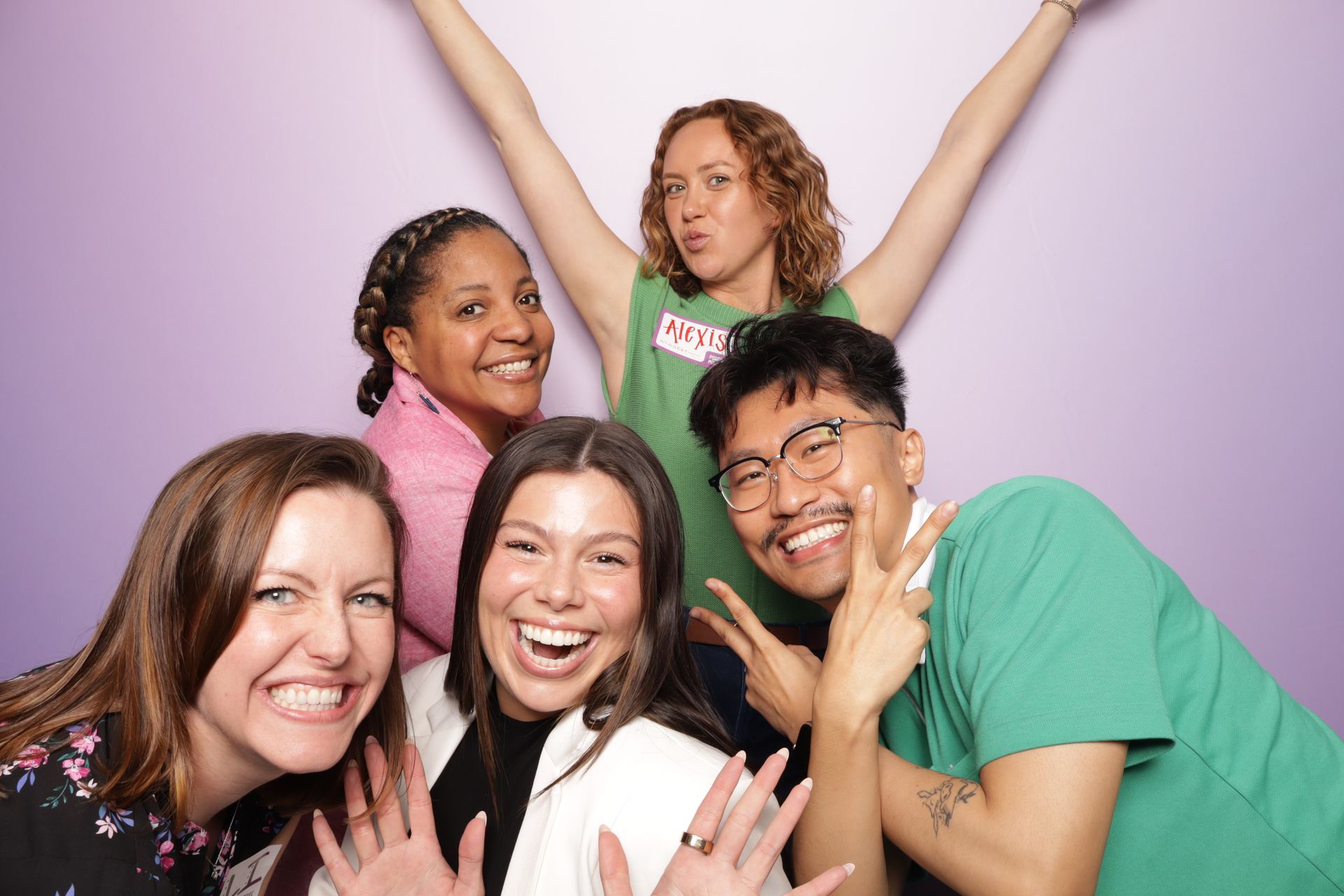 five people posing for a photo booth