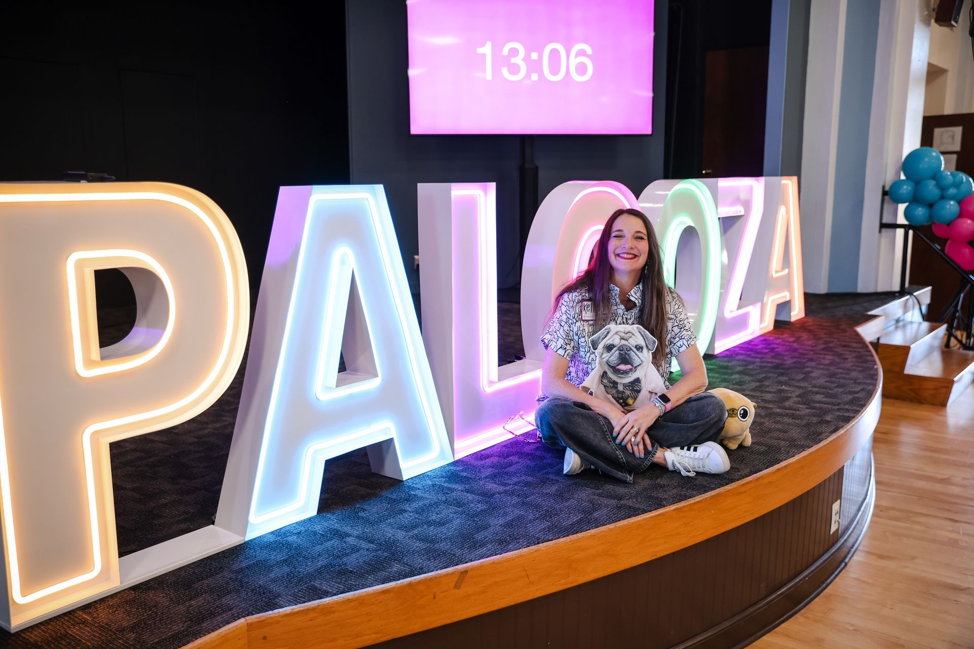 photo of woman in front of sign that reads 