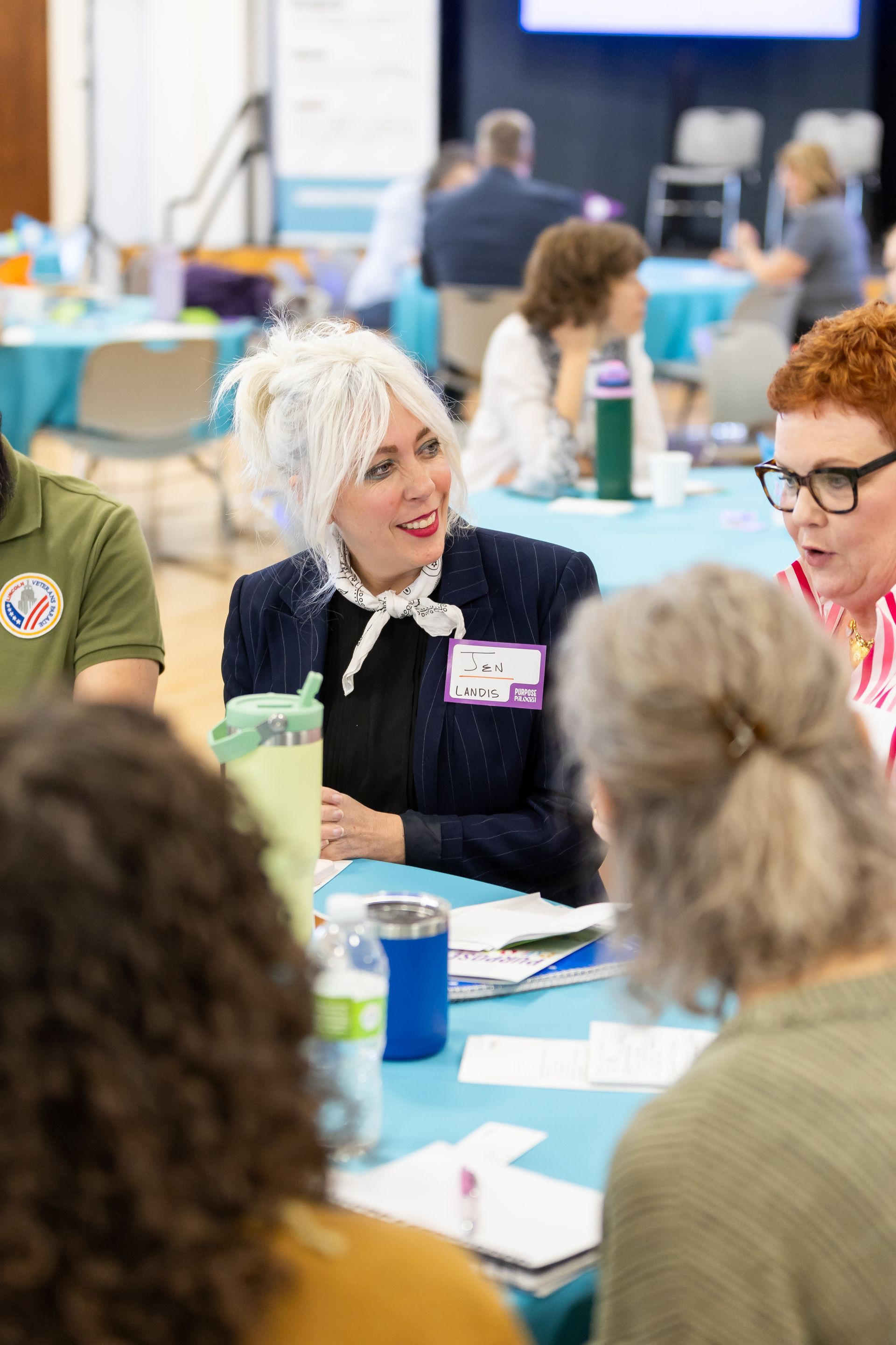 photo of woman listening to someone else sitting at the same table