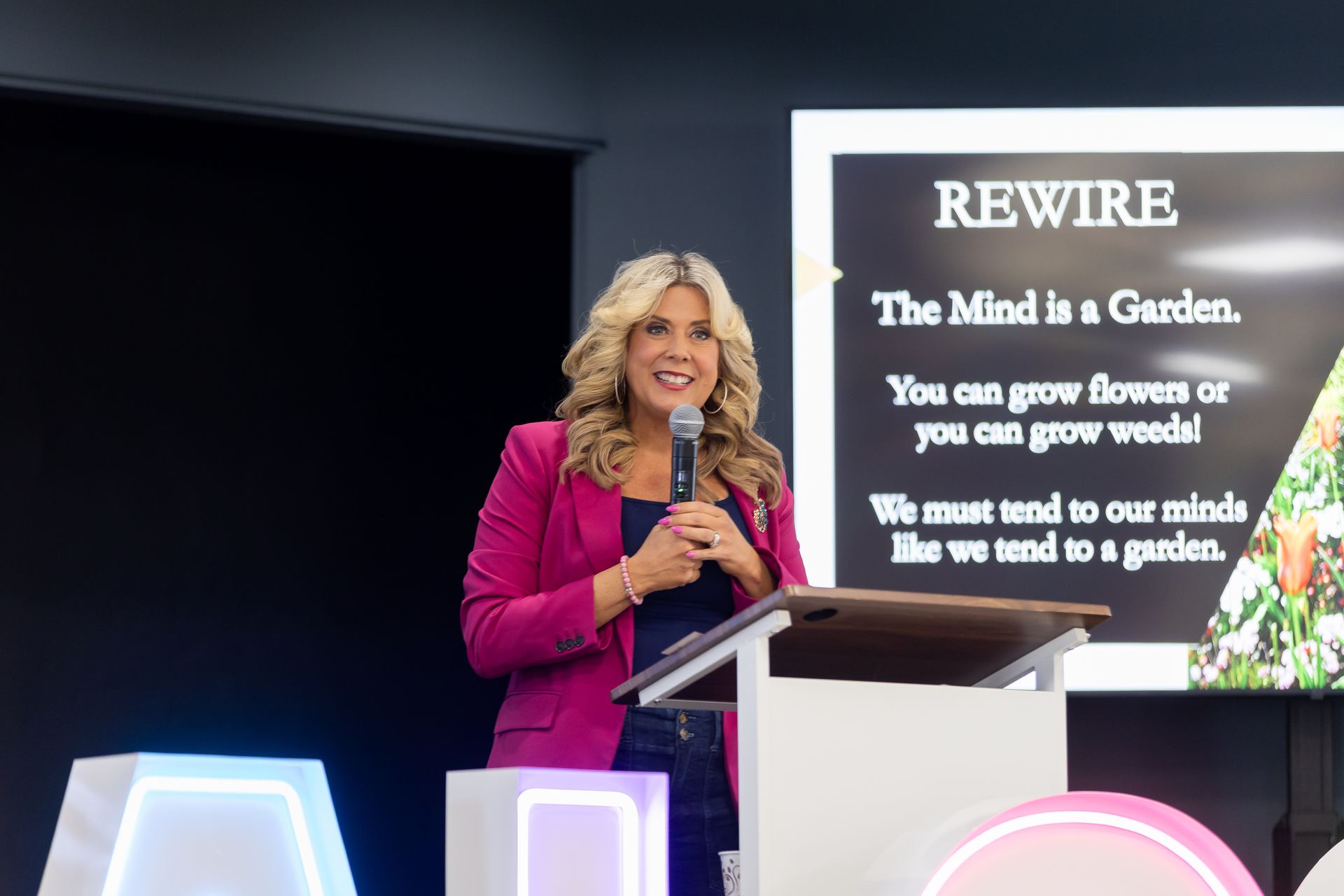 photo of woman at a podium speaking into a microphone
