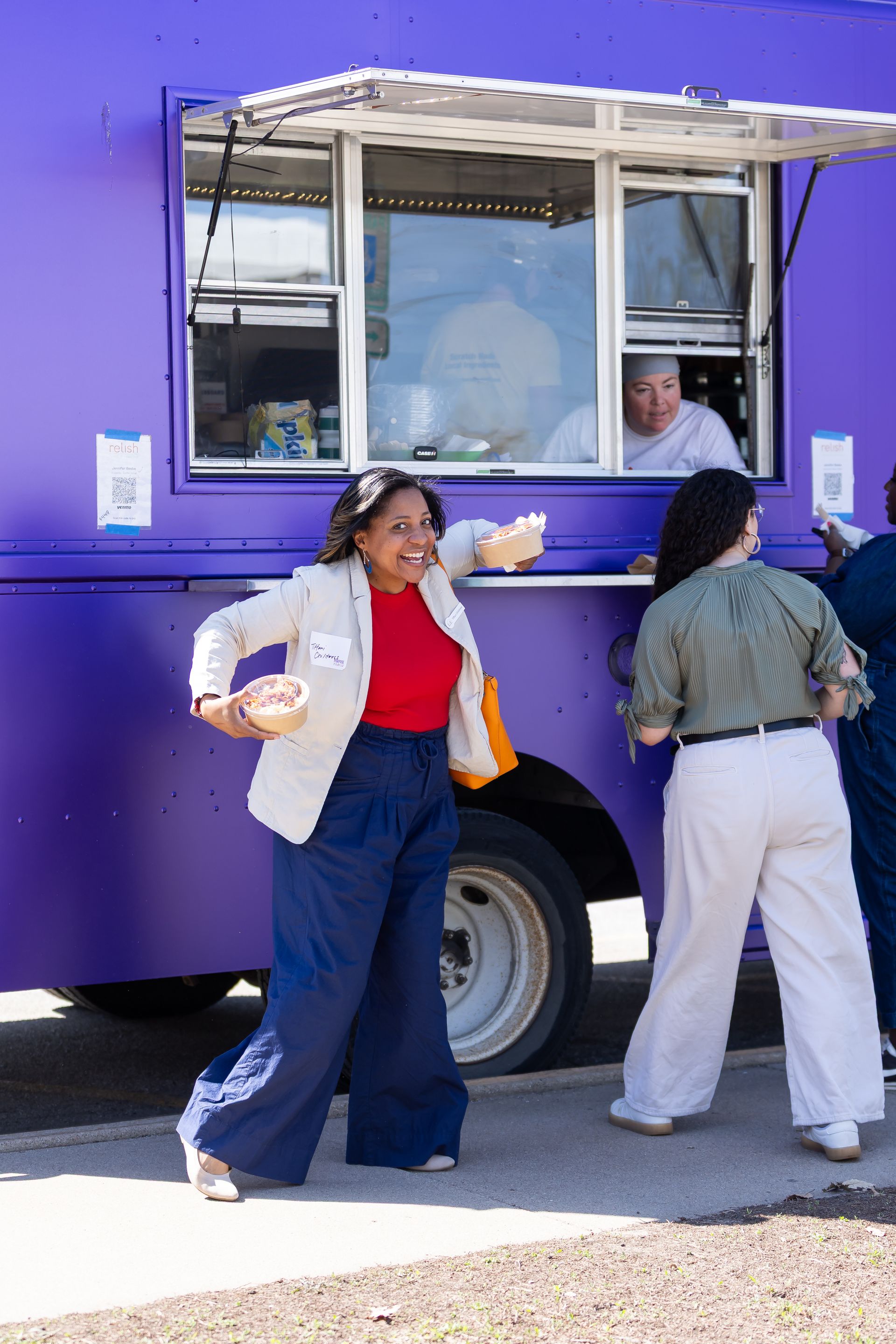 photo of woman posing in front of a food truck