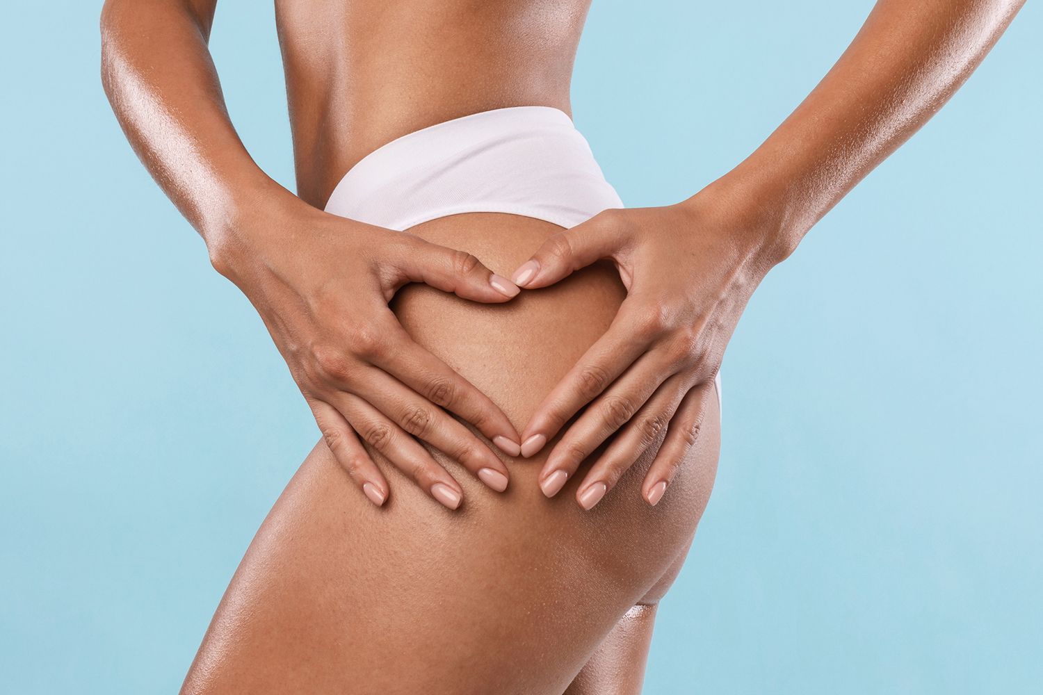 Woman making heart sign gesture on buttocks