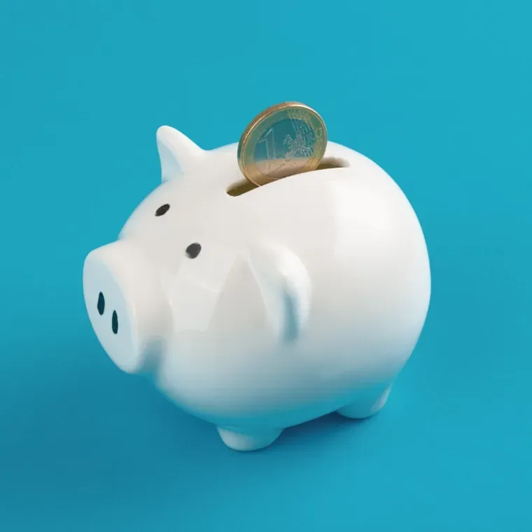 A piggy bank with a coin in it on a blue background
