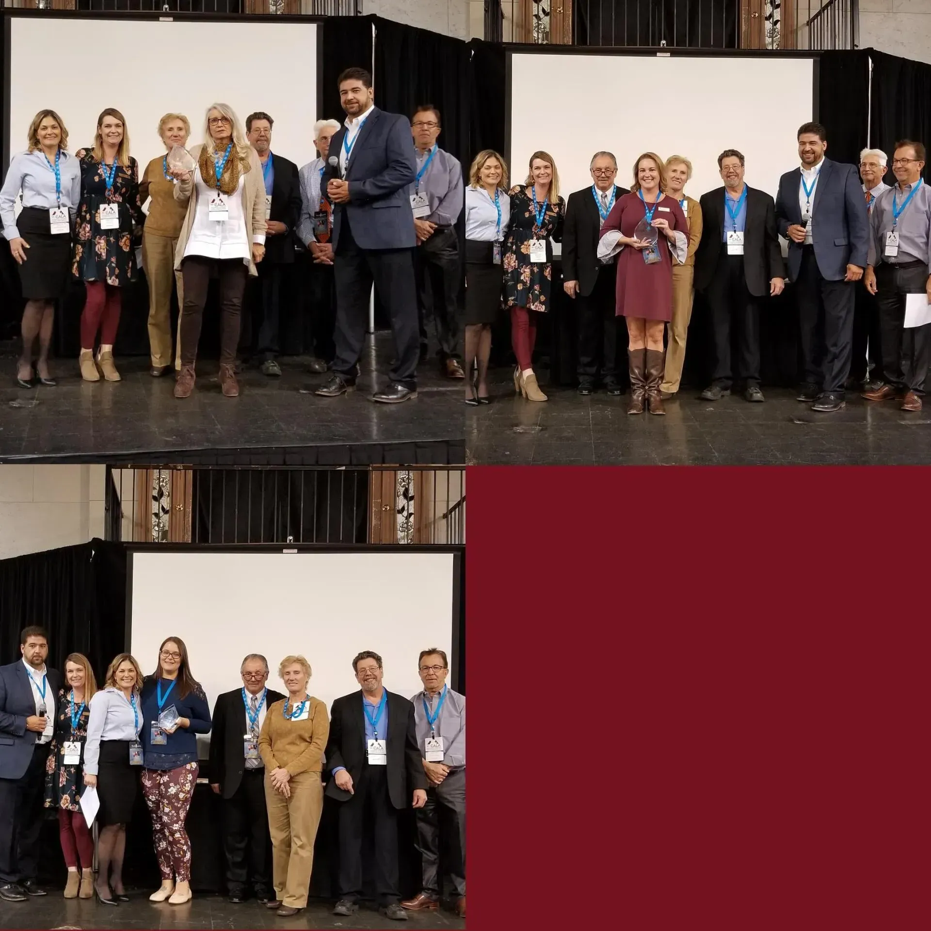 Group of people posing with awards on a stage in front of white screens.
