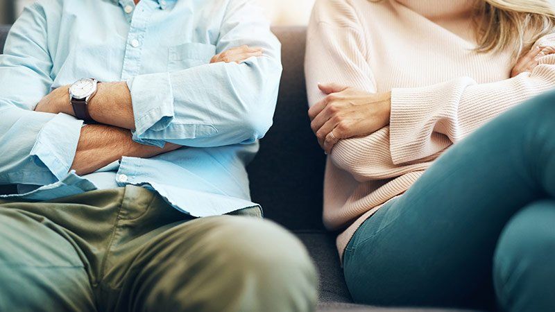 two people sitting down with their faces out of frame