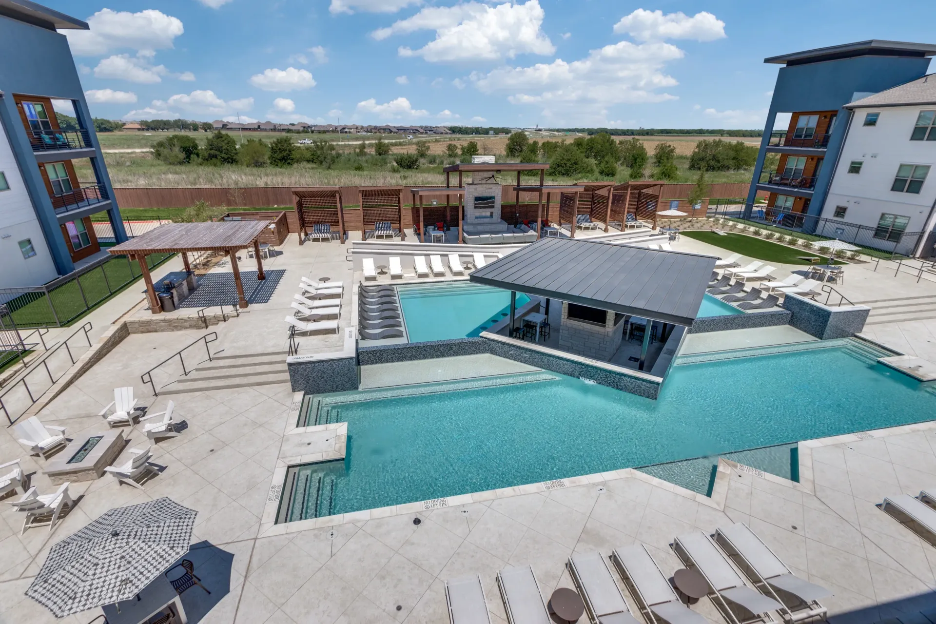 Luxurious community pool area with cabanas, lounge chairs, and a swim-up bar.