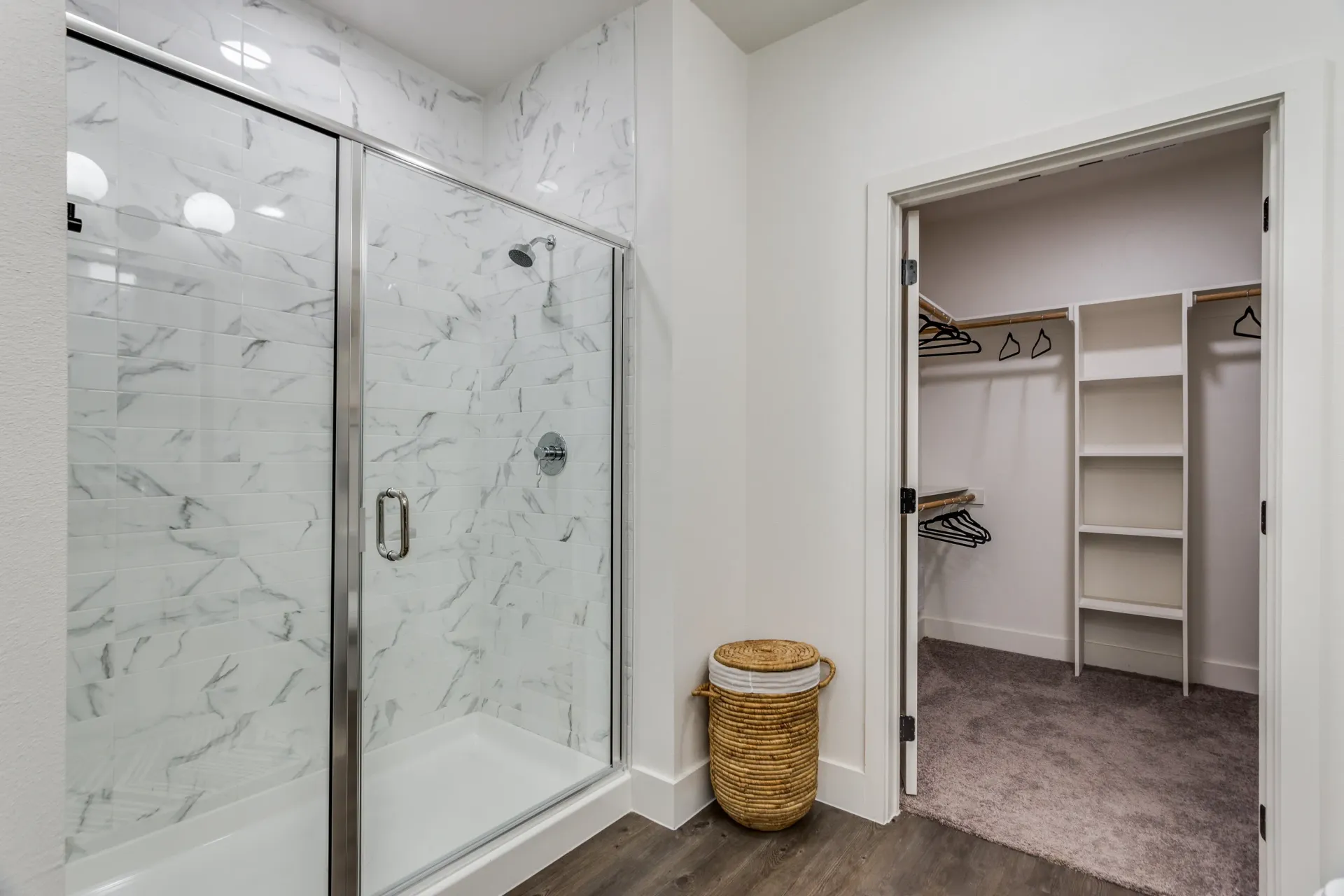 Modern bathroom with a walk-in shower and a spacious closet.