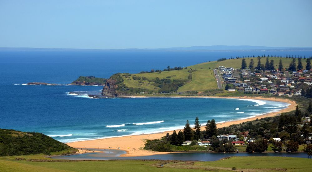 Coastal Landscape with Blue Ocean, Sandy Beach and A Small Town — Burnett Trees in Mount Pleasant, NSW