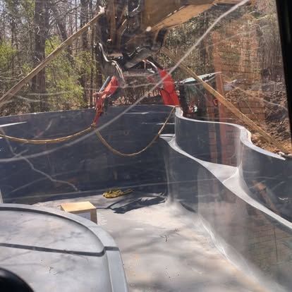 Damaged trampoline with torn safety net and bent poles in a wooded backyard