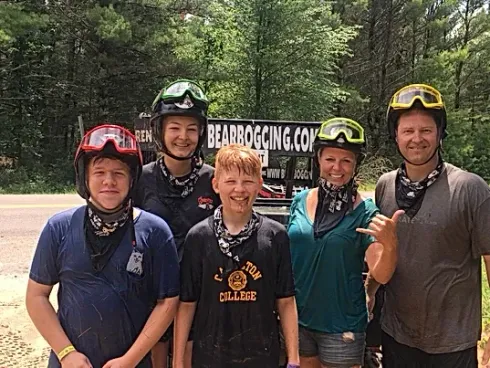 A group of people wearing helmets and goggles are posing for a picture.