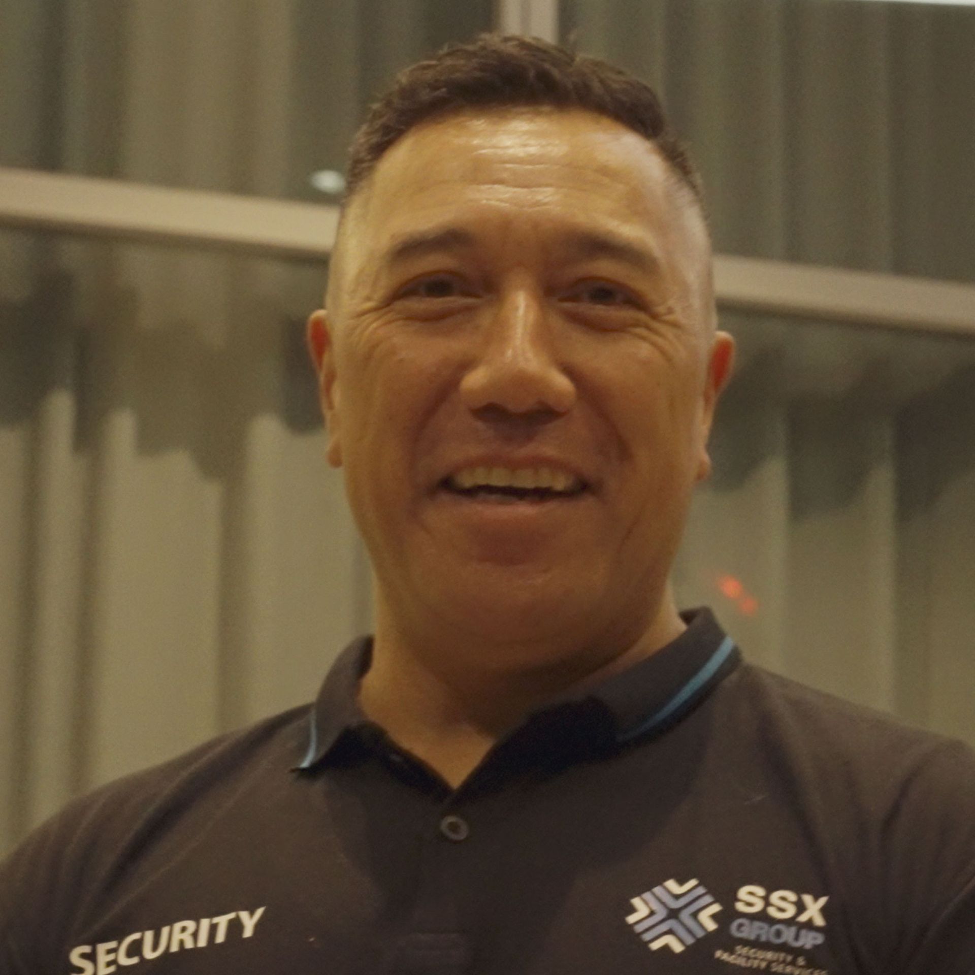 Security officer standing alert at a workplace entrance